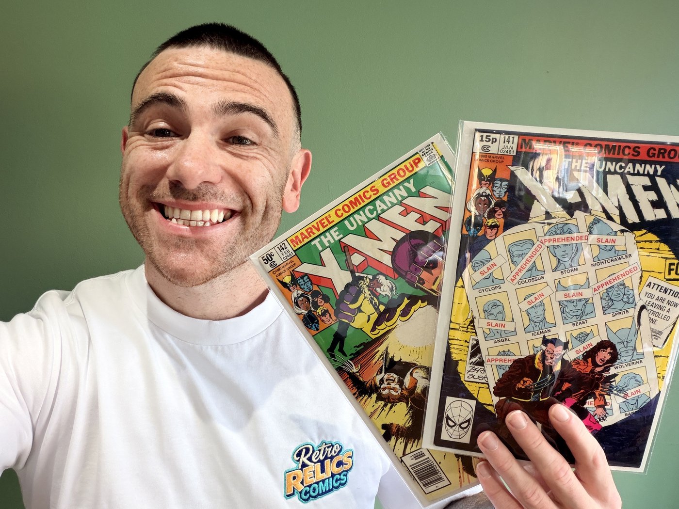 Lee from Retro Relics Comics holding Uncanny X-Men #141 and #142, Days of Future Past, cover art showing the X-Men roster marked slain or apprehended